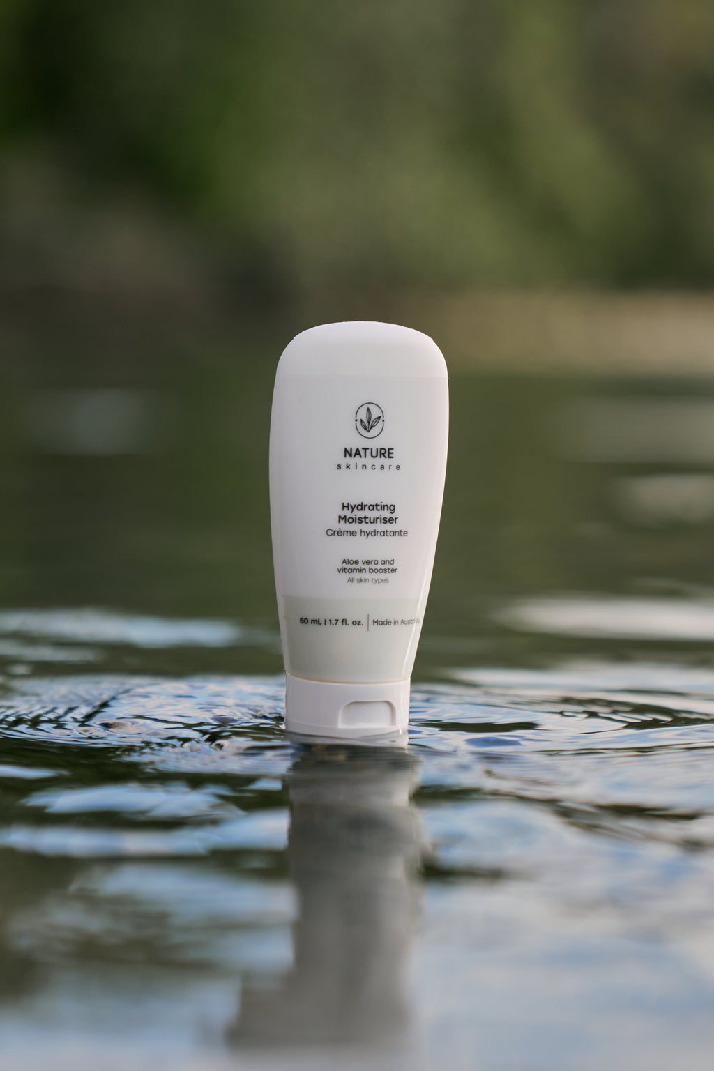 Hydrating moisturiser tube standing in shallow water