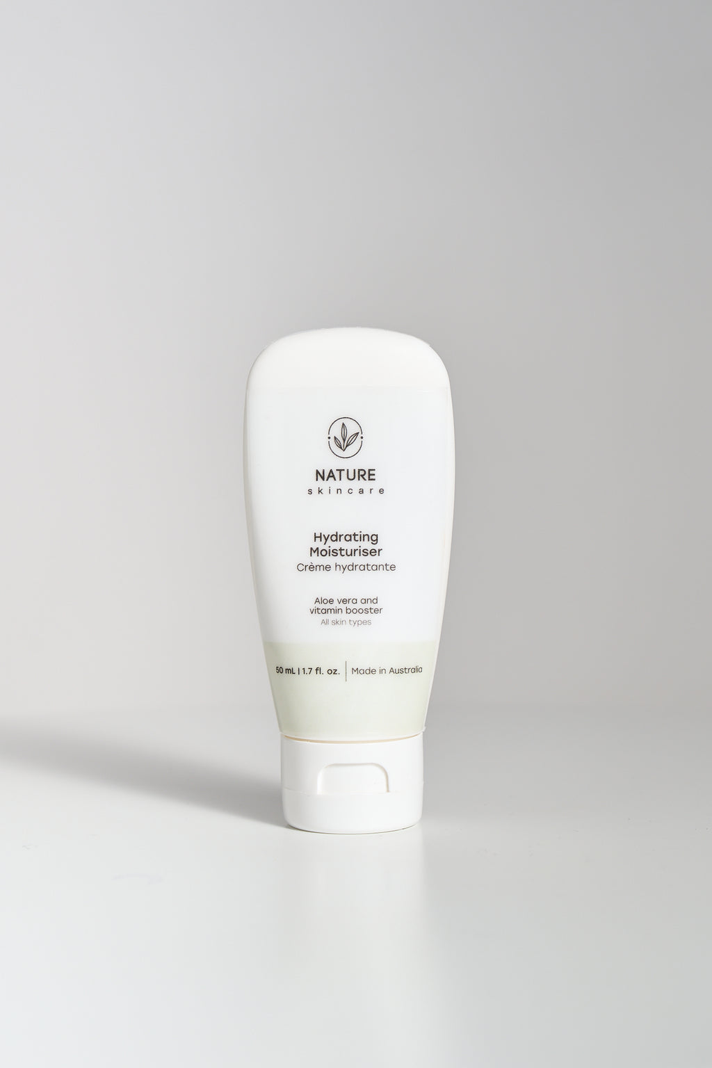 Hydrating moisturiser tube standing upright on a neutral background