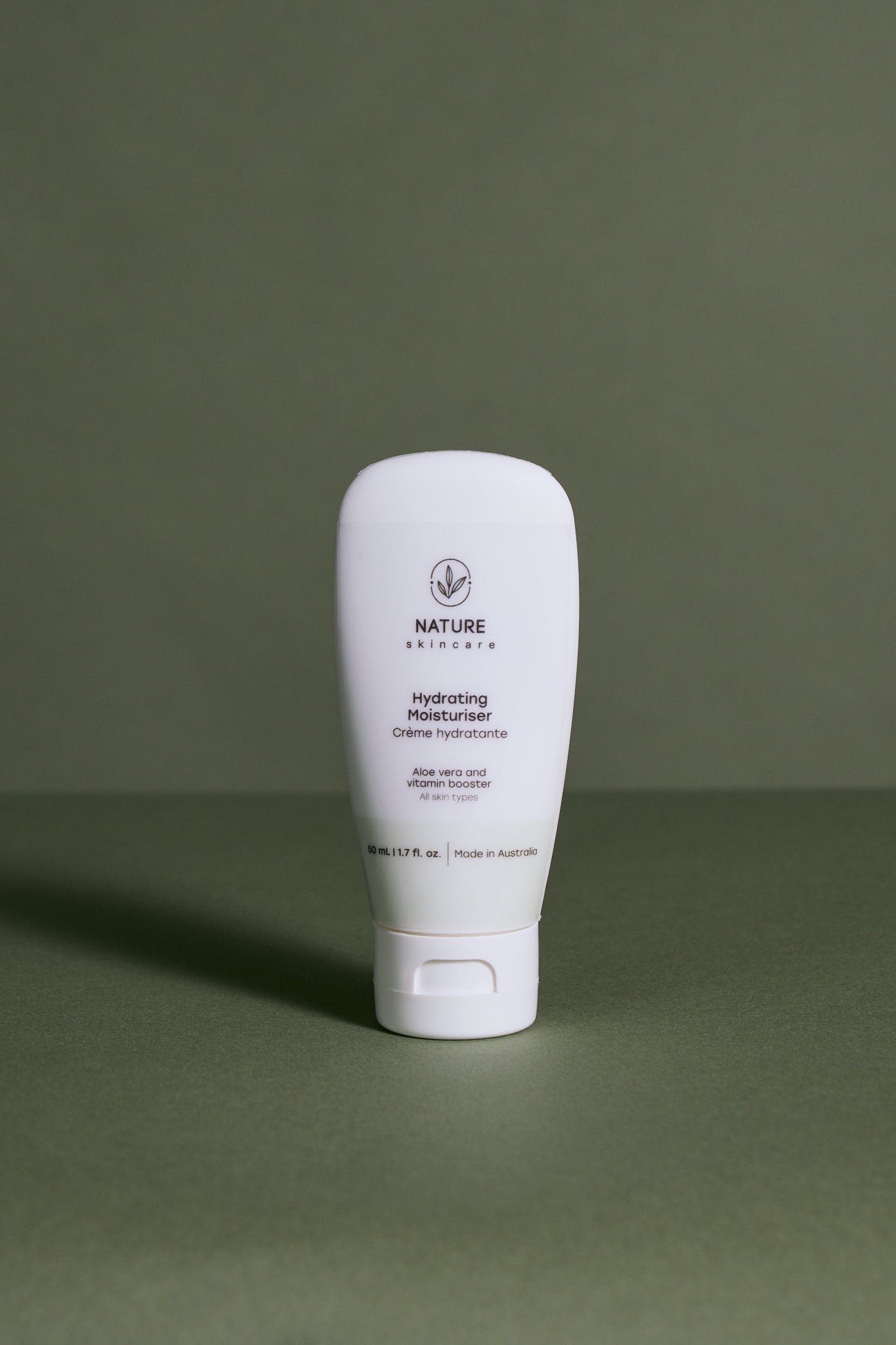 White skincare product bottle hydrating moisturiser labeled Nature Skin care on a green background