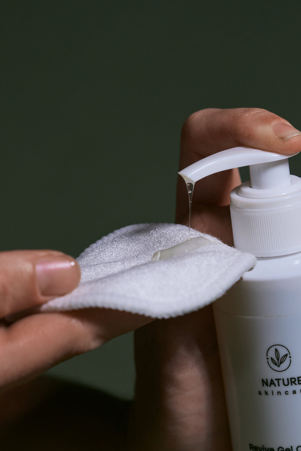 Close-up of cleanser being dispensed onto a reusable cotton pad