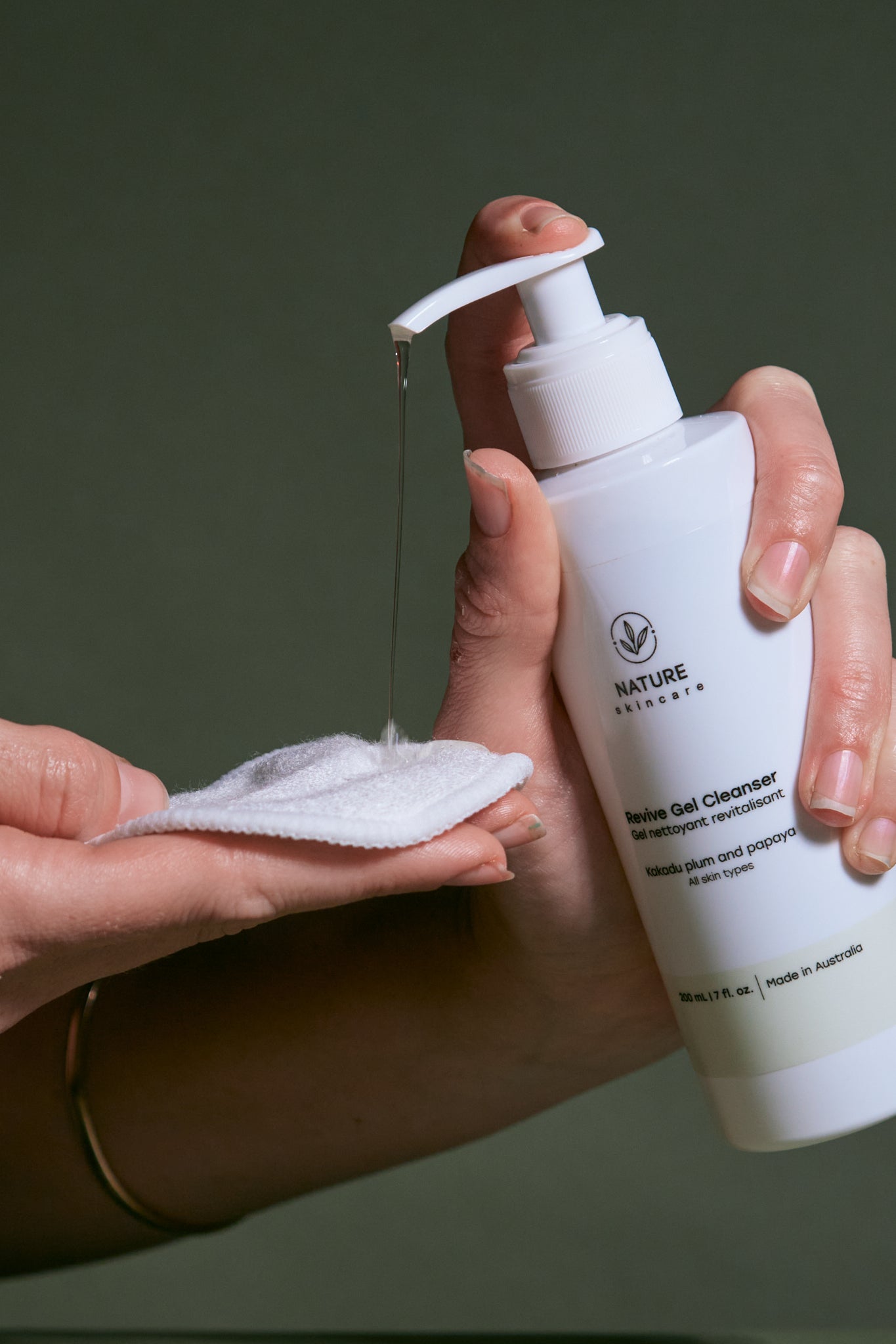 Revive gel cleanser being dispensed onto a reusable cotton pad