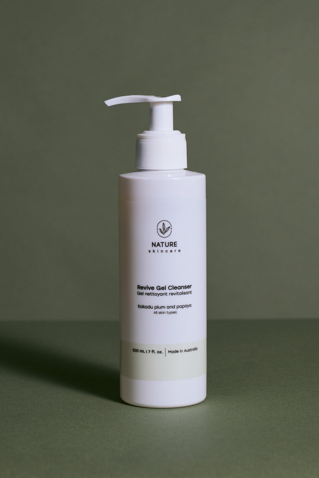 Revive gel cleanser pump bottle on a green background