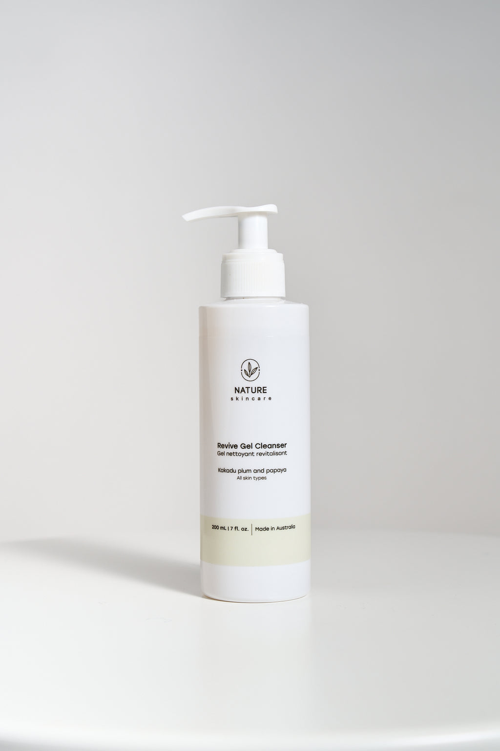 Revive Gel Cleanser pump bottle standing on a neutral background