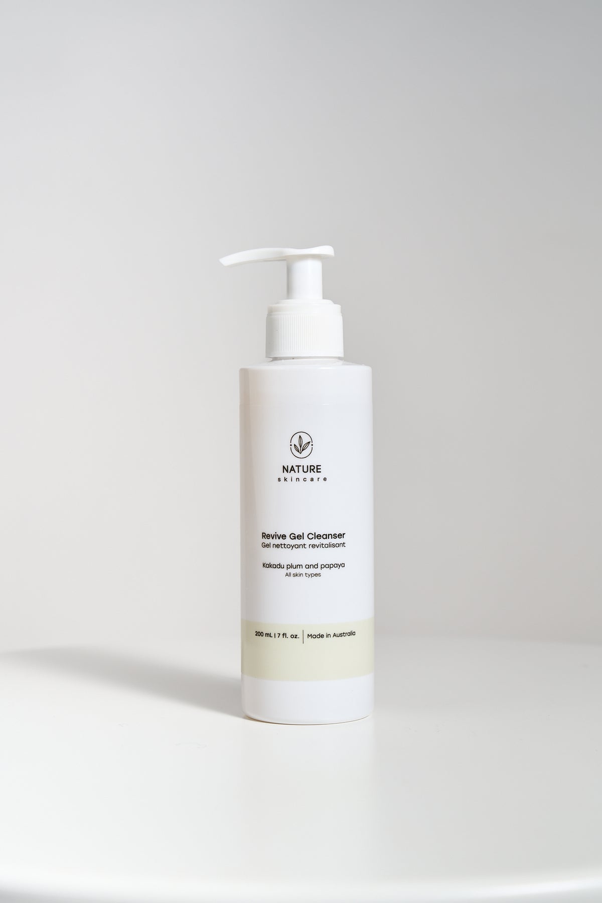 Gel facial cleanser pump bottle on a neutral background without people